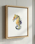 Watercolor seahorse artwork in soft coastal blues, sandy neutrals, and golden tones on a white background. Coastal-inspired wall art by Pink Sky Design.
